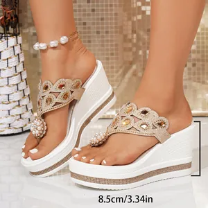 White wedge flip-flop sandals featuring rhinestone details and 8.5cm platform heel