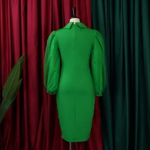 Detailed back view of a green bodycon pencil dress featuring elegant mesh puff sleeves