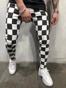 Detailed view of men's trendy black and white checkerboard skinny fit streetwear pants