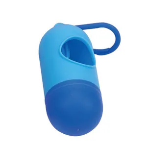 Capsule-shaped blue dog waste bag dispenser with carabiner for leash attachment.