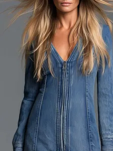 Close-up detail of a stylish blue denim mini dress featuring a central front zipper design