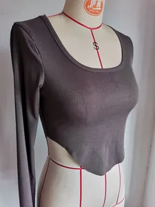 Detailed view of cropped ribbed long sleeve top with asymmetrical hem and square neckline
