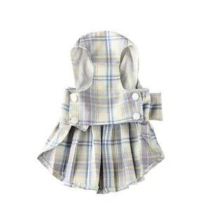 Macro detail of plaid pet JK harness dress with white snap buttons and mesh lining