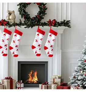 Four festive red and white knitted Christmas stockings hanging on a cozy fireplace mantel.