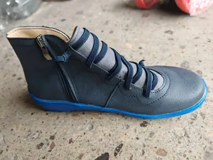 Side view of retro blue casual short boots with zipper and flat sole detail