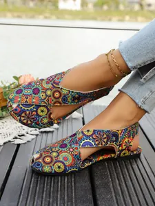 Detailed view of ethnic printed flat sandals with breathable cross-strap design.
