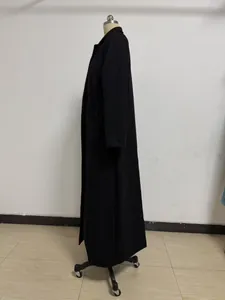 Side view of a long black wool coat for women, elegant warm winter overcoat detail