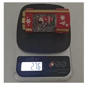 Santa Claus Christmas snow lantern weight measurement on a digital kitchen scale at 276g