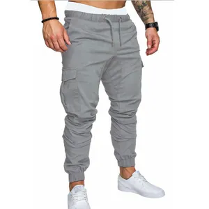Detailed view of grey men's slim fit multi-pocket cargo jogger pants with drawstring waist