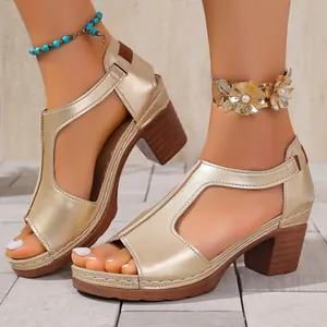 Close-up of elegant gold chunky heel sandals featuring a stylish cutout T-strap design on feet