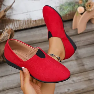 Macro detail view of red textured suede slip-on wedge loafers for women casual wear