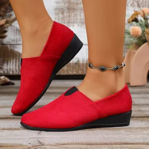 Red suede wedge loafers for women with a comfortable slip-on design for daily wear.