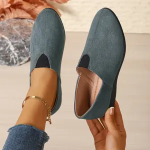 Close-up of women's grey suede pointed-toe loafers with comfortable elastic wedge