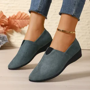 Detailed view of grey-blue suede wedge shoes with pointed toe and elastic band