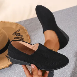 Close-up of black suede wedge loafers with a pointed toe and slip-on design.
