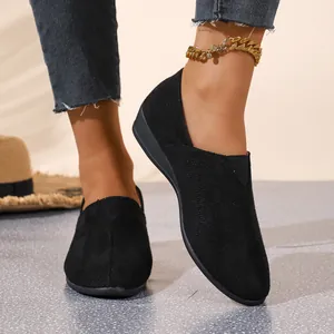 Detailed view of women's black suede wedge loafers with pointed toe and slip-on design