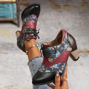 Detail of vintage ethnic floral print ankle boots with chunky high heels for women.