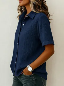 Detailed side view of women's navy blue textured cotton short-sleeve button-down shirt.