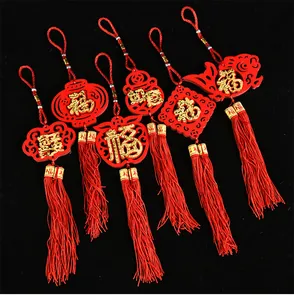 Detail view of 6 Chinese New Year felt ornaments with red tassels and gold Fu characters