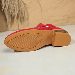 Detailed view of red suede ankle boot sole with block heel and size mark 37