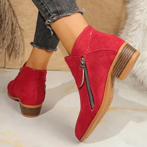 Side view of red suede ankle boots showing double zipper detail and chunky heel