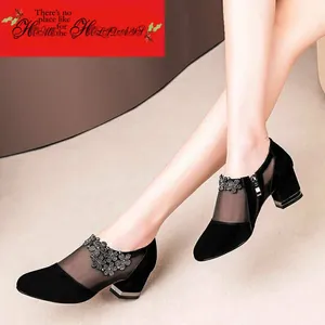 Close-up detail of black frosted mesh pumps with elegant rhinestone flower accents