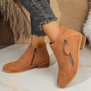 Detailed view of camel suede ankle boots with double side zippers and block heel