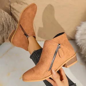 Close-up detail of women's camel faux suede ankle boots with functional double side zippers