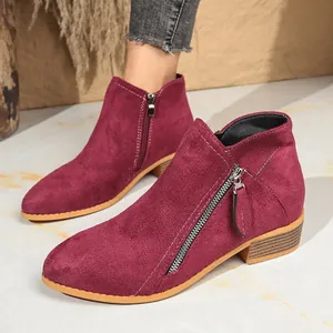Detailed side view of burgundy suede ankle boots featuring double side zippers and low chunky heel