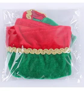 Festive red and green velvet elf wine bottle cover with gold trim for Christmas table