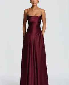 Close-up detail of a luxurious burgundy satin evening dress with pleated bust detail