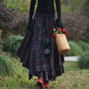 Detailed view of the layered irregular hem on this green plaid maxi skirt for women.