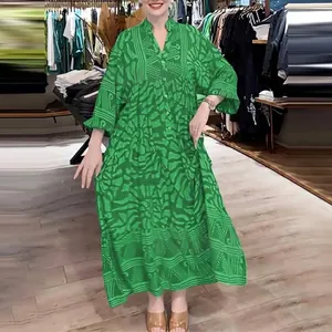 Detailed view of a green printed loose maxi dress with long sleeves for women.