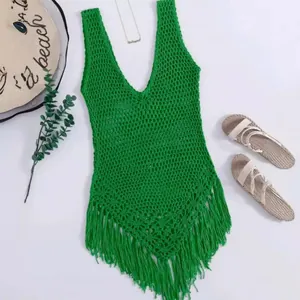 Detailed view of bright green bohemian crochet beach cover-up featuring fringe hem