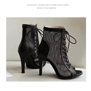 Detailed close-up view showing the black mesh texture and lace-up high heel design