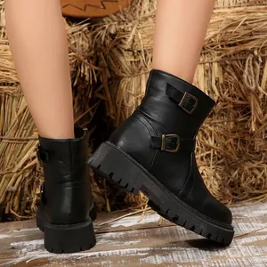 Side view of black vintage motorcycle boots with dual buckle straps and chunky lug soles