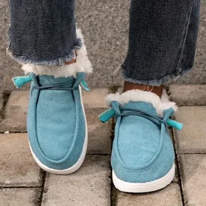 Gros plan de mocassins d'hiver en velours bleu avec doublure en fausse fourrure blanche