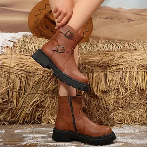 Brown retro faux leather motor boots for women featuring double buckles and thick lug soles