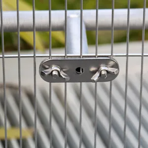 Close-up of stainless steel bird perch fixing hardware with wing nuts on cage wire