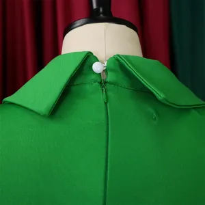 Detailed close-up of green pencil dress back showing hidden zipper and white button collar.