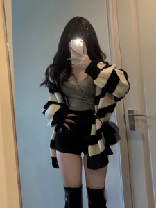 Stylish oversized black and white striped knit cardigan for women in a mirror selfie view