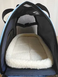 Close-up detail of breathable pet carrier interior showing comfortable white fleece cushion