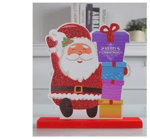 Close-up detail of wooden Santa Claus tabletop decoration featuring Merry Christmas text