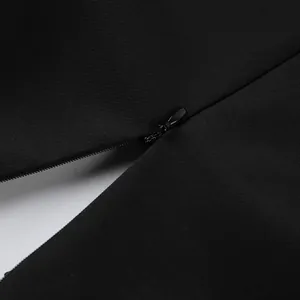Close-up detail showing the high-quality hidden invisible zipper on black elegant suit dress