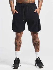 Detailed view of men's black four-way stretch quick-dry cargo sports shorts on model