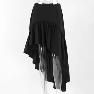 Detail view of the asymmetric ruffled hem on this elegant black high-waisted skirt