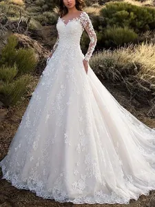 Exquisite long-sleeved lace wedding dress with intricate floral embroidery and train