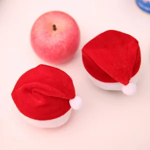 Two mini red velvet Santa hats for Christmas apple decoration and table ornaments