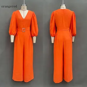 Front and back views of a vibrant orange-red deep V-neck loose jumpsuit with puff sleeves