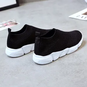 Rear view of black breathable fly-knit sneakers with white flexible sole